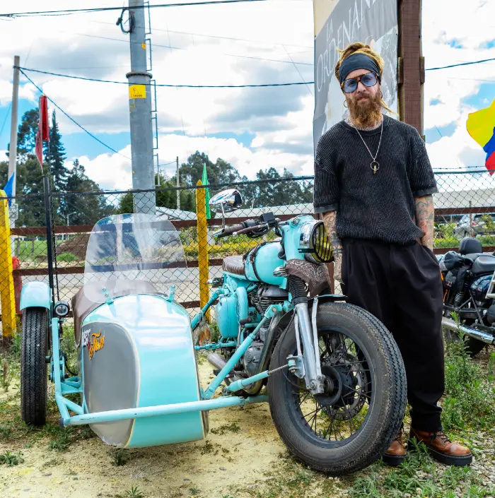 Motero posando al lado de su Royal Enfield color turquesa en el one ride Colombia 2025